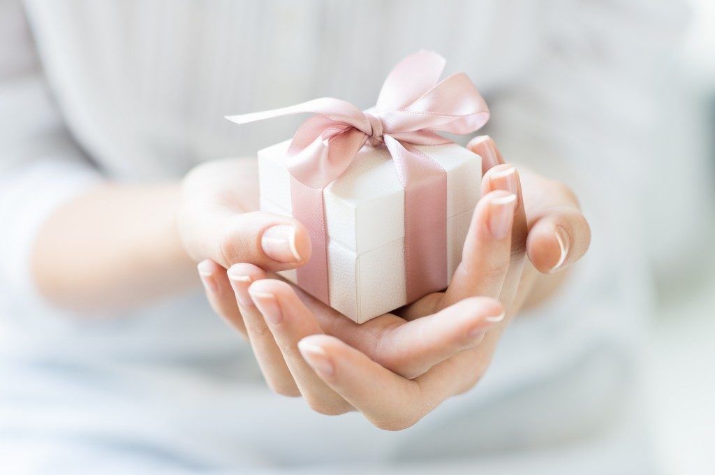 woman holding a small gift box